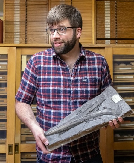 Photograph of Robert holding an ichthyosaur fossil